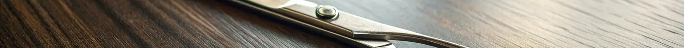 A pair of the best Japanese hairdressing scissors with premium steel blades on a wooden table.