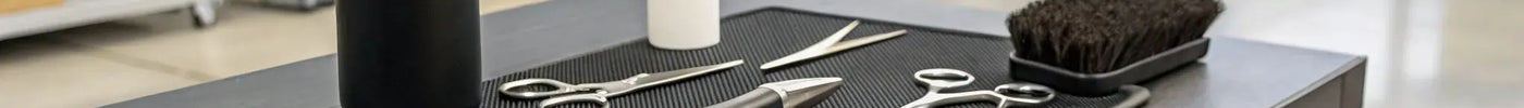 Professional barber equipment like clippers and shears from a wholesale distributor.