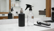 Continuous mist and trigger barber spray bottles on a workstation