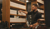 Professional barbershop backbar stocked with jars and canisters of styling powder