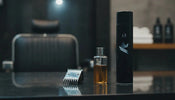 Clipper oil and blade coolant beside a professional barber clipper blade