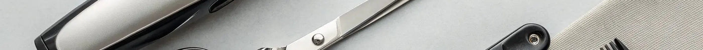 A collection of professional barber tools for sale, including clippers, shears, and a comb.