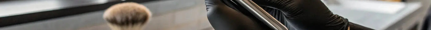 Professional barber holding a precision eyebrow trimmer in a salon.