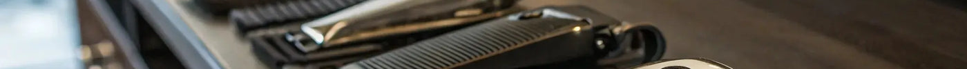 A hair clipper with a full set of numbered guards showing different hair cutting sizes.
