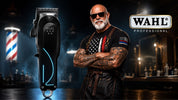 Wahl Professional black cordless clipper with blue LED accents beside The Barber Company barber character in a modern barbershop setting.