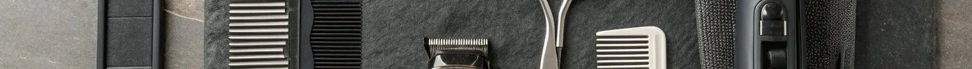 Essential professional barber tools including clippers, shears, combs, and a trimmer.