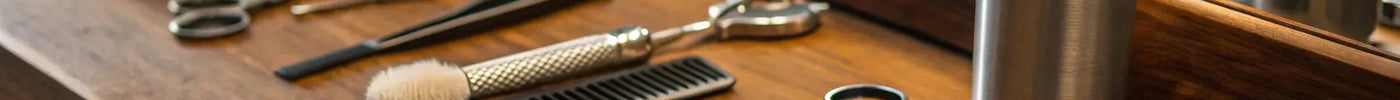 A professional barber kit with everything needed, including scissors, combs, a brush, and sanitizer.