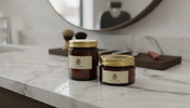 Two premium pomade jars on a sleek countertop in a modern barbershop
