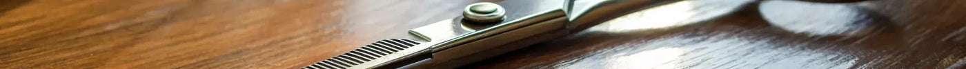 A pair of Kamisori shears on a table with a coupon code for a discount.