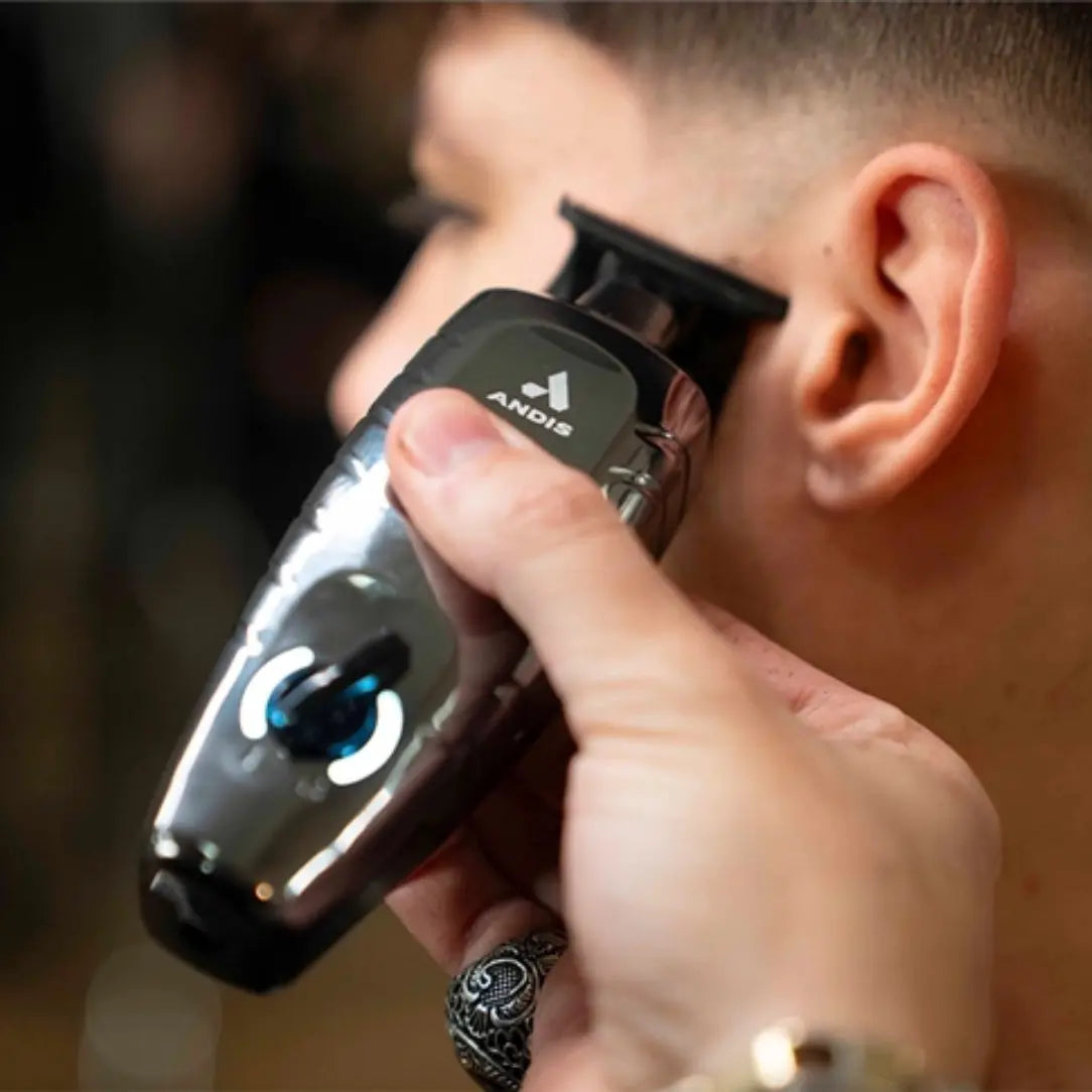 “Barber outlining beard using cordless Andis GTX‑EXO II trimmer”