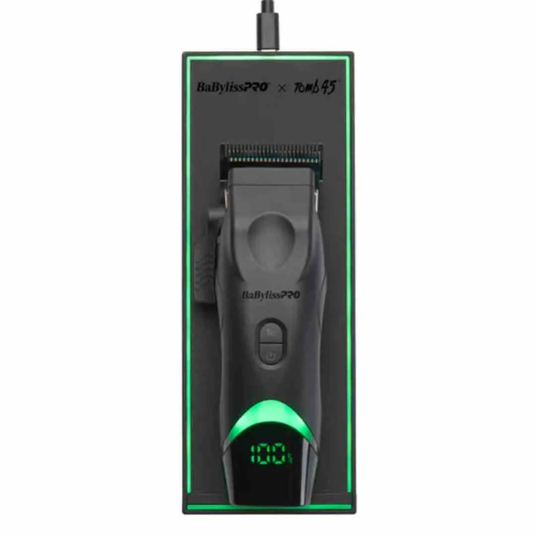 A BaBylissPRO x Tomb45 wireless charging pad with an aligned clipper on it, showing the LED rim indicator and USB-C port.