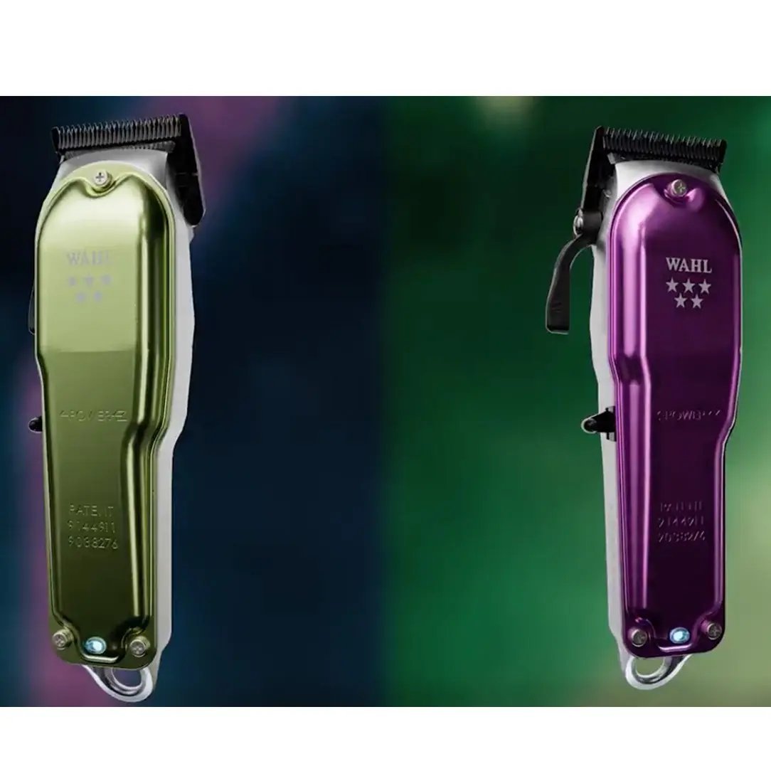 Two Wahl hair clippers, one gold and one purple, on a gradient background.