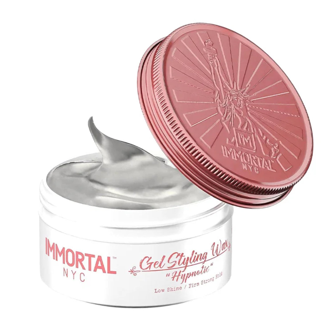 “Man applying Hypnotic Gel Wax to damp hair, creating textured, semi-matte hairstyle.”