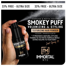 Hand holding a bottle of Smokey Puff volumizing and styling hair powder with product packaging in the background.