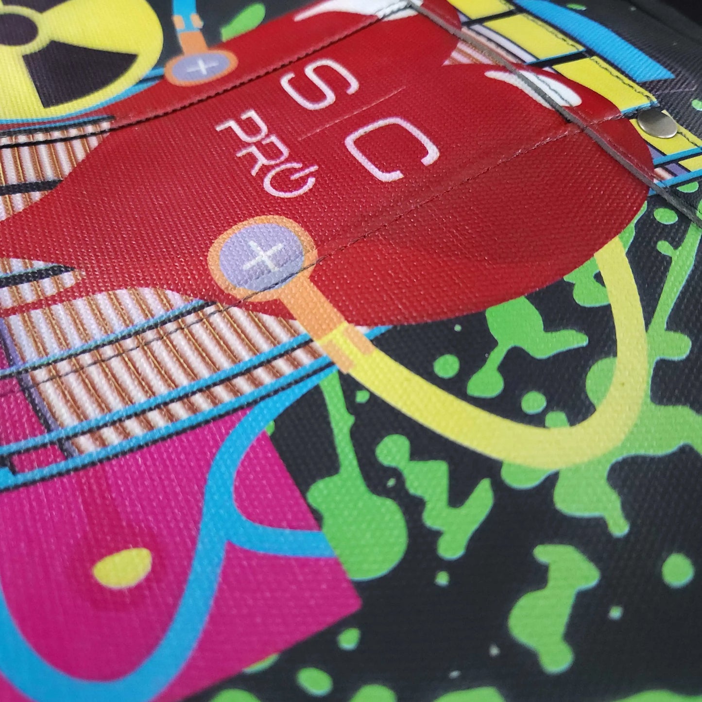 StyleCraft Radioactive Apron Colorful fabric with a red label and various patterns