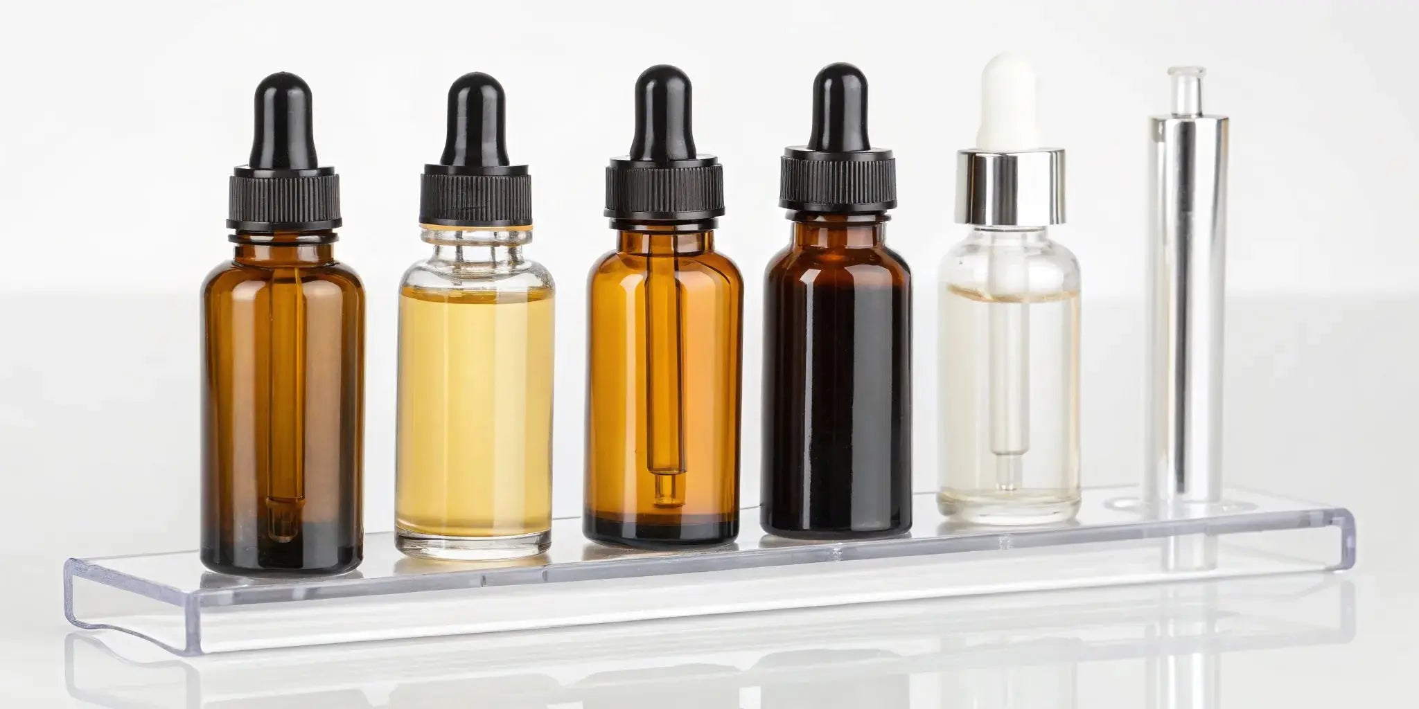A selection of the best oils for professional hair clippers in dropper bottles.