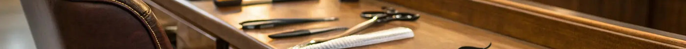 A professional barber combo set with clippers and trimmers on a workstation.