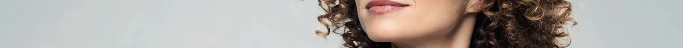 A woman's defined and healthy curly hair, styled to be client-ready.