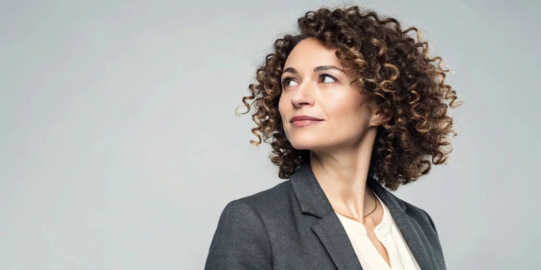 A woman's defined and healthy curly hair, styled to be client-ready.
