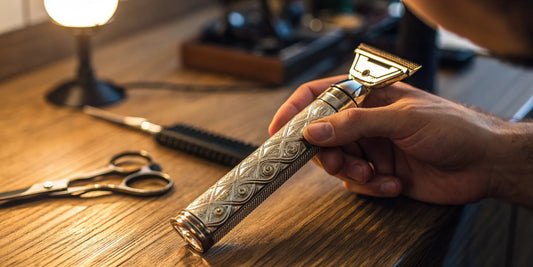 Barber holds an Andis T-Outliner trimmer with its replacement blade for hair and beards.