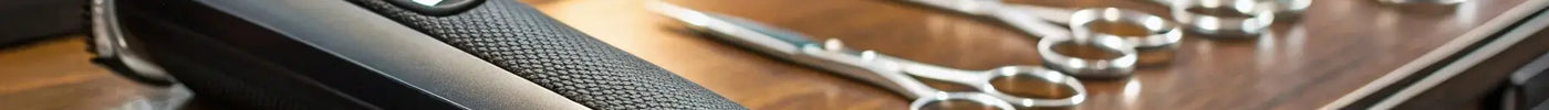 A BaByliss FX trimmer with its precision blade on a professional barber station.