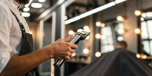 BaBylissPRO Barberology cordless metal double foil shaver held by a barber.