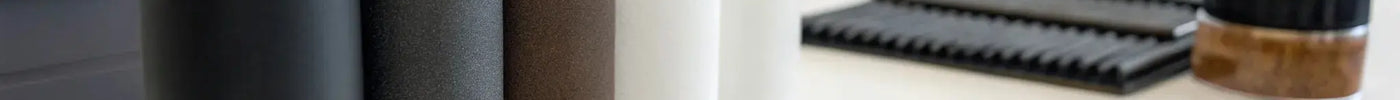 Bottles of wholesale hair fibers in various shades for barbers.