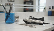 Professional barber tools on marble countertop with glass disinfectant jar