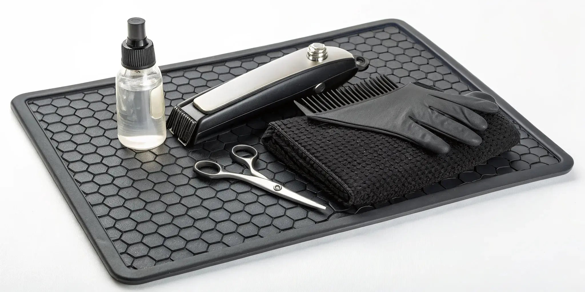 A clipper maintenance kit with oil, a brush, and blade wash for cleaning clippers.