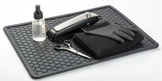 A clipper maintenance kit with oil, a brush, and blade wash for cleaning clippers.