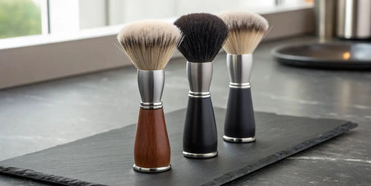Three professional neck dusters with different bristle types and handles.