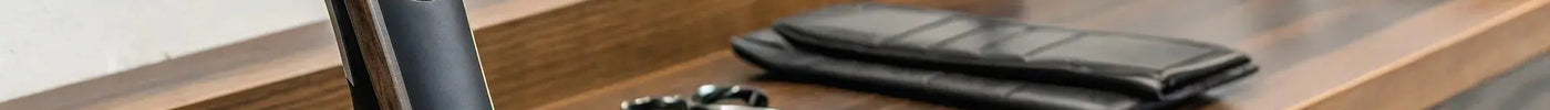 Professional beard trimmer in a charging stand on a barber's counter.