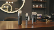 A premium professional cordless barber combo set on a wooden barber station featuring a high-performance hair clipper, precision trimmer, and shaver.