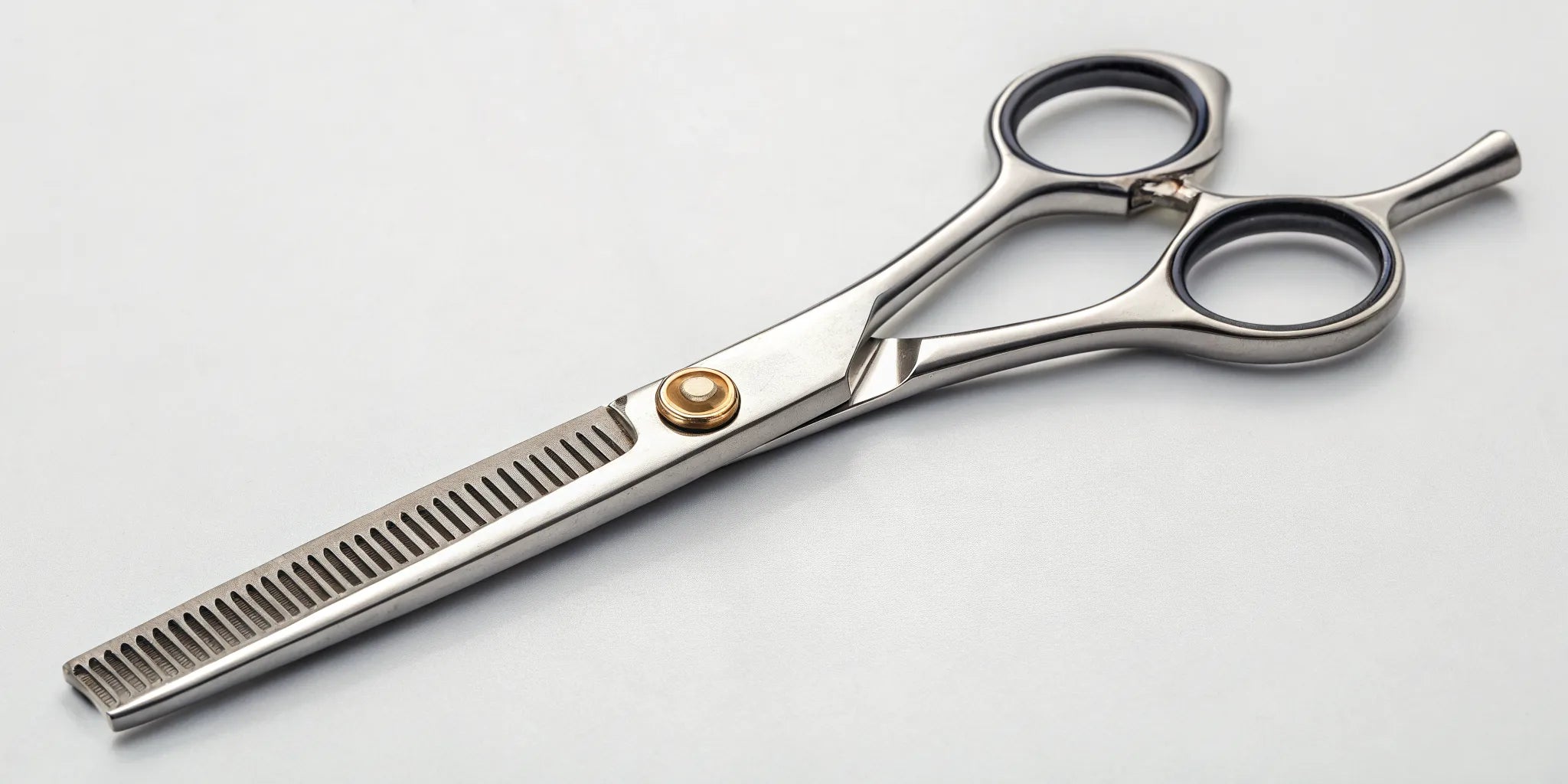 Texturizing shears with a notched blade used for adding texture and blending layers.