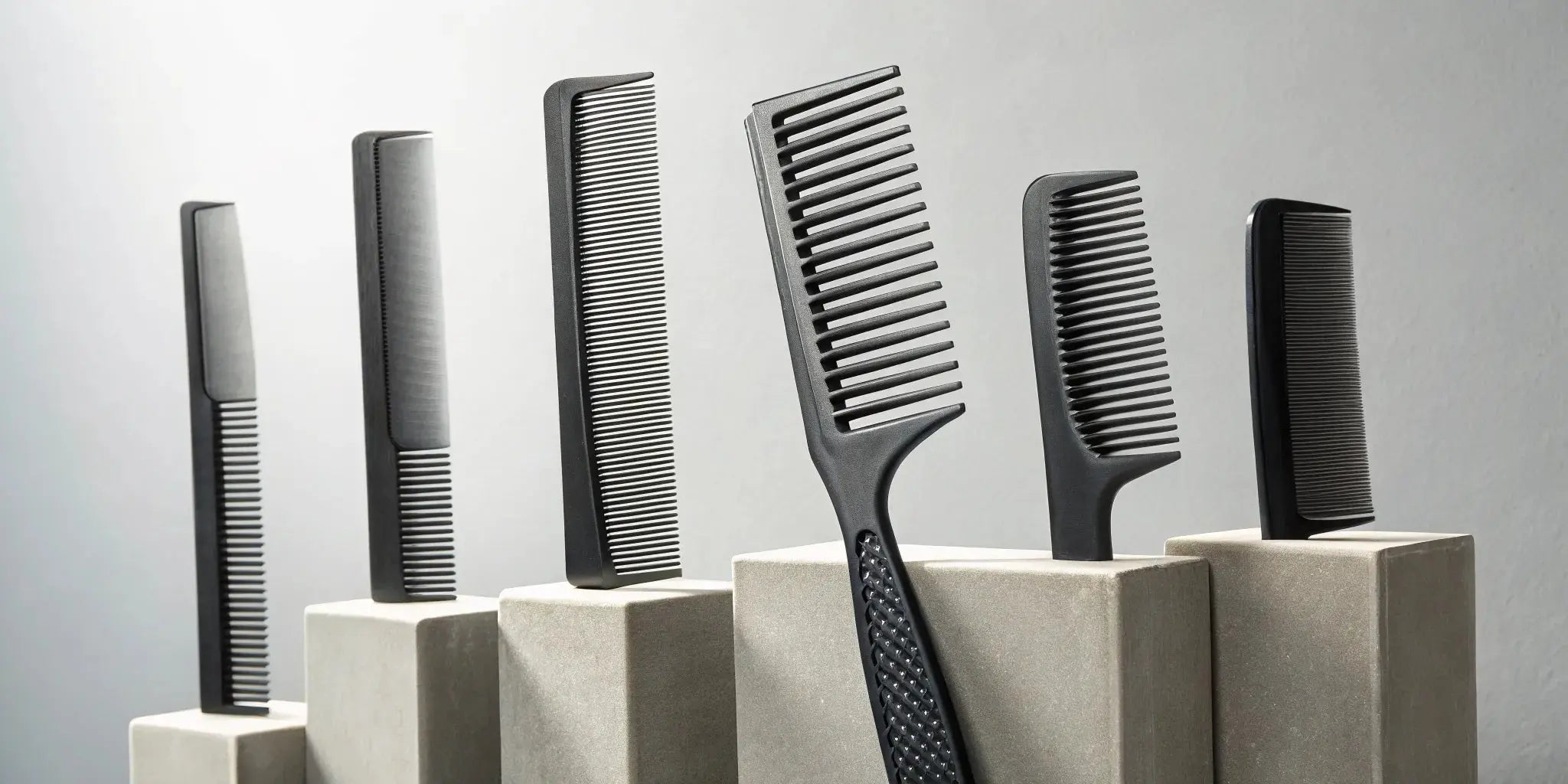 A professional carbon fiber comb set for barbers being reviewed.