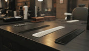 Professional barber combs arranged on a barbershop counter with warm ambient lighting