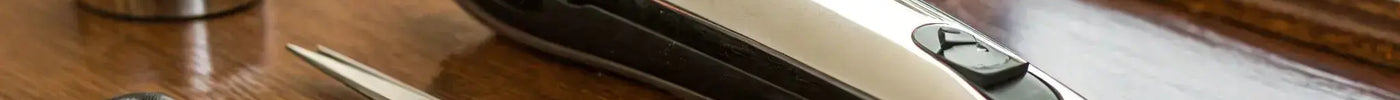 Wahl 9685 clippers with scissors and comb on a barber’s workstation.