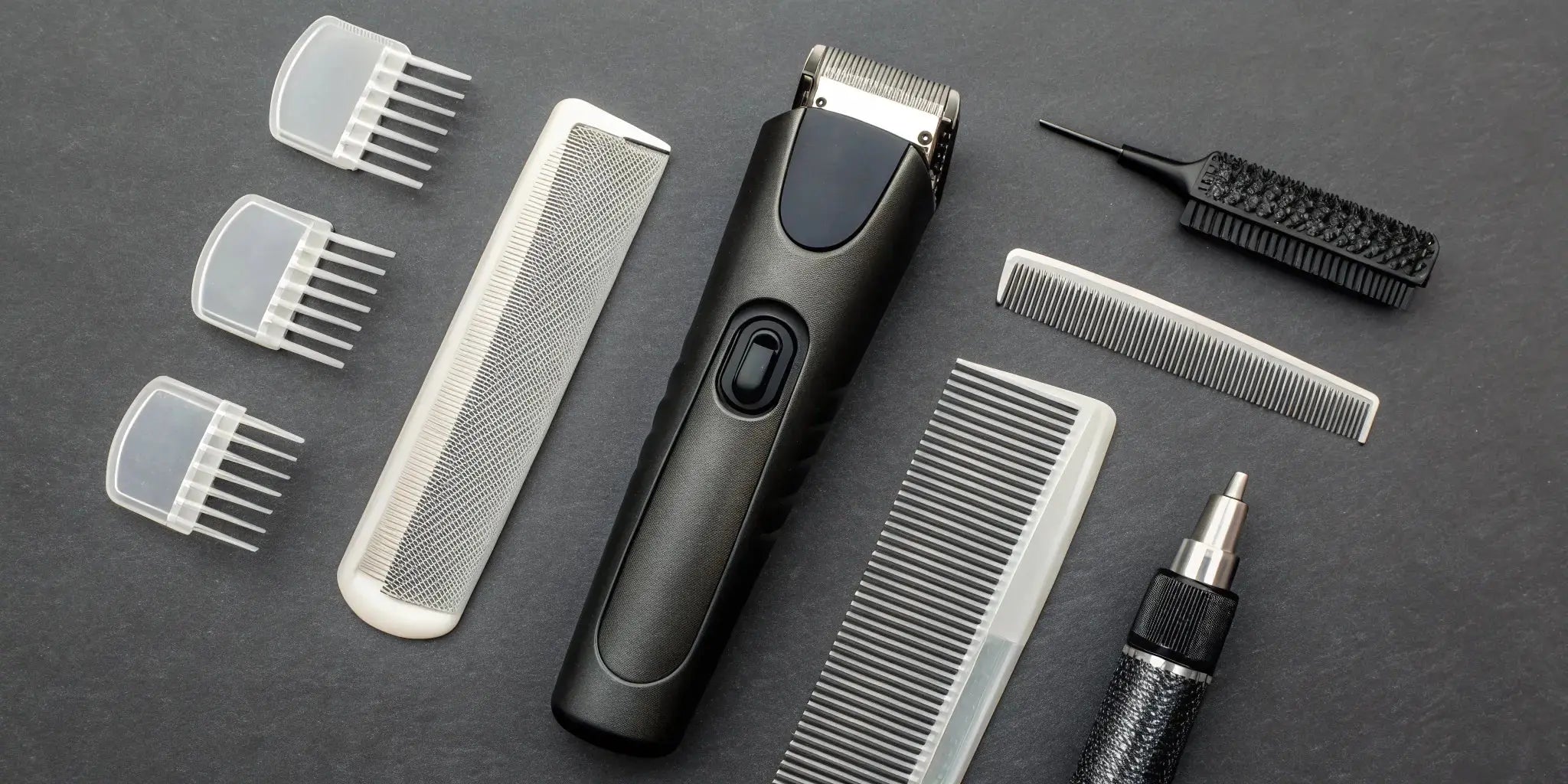 A clipper and trimmer maintenance kit with essential tools like a cleaning brush and blade oil.