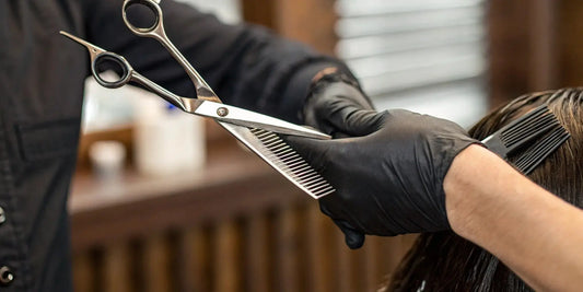 Handmade Japanese steel scissors used by a professional barber for a precision haircut.