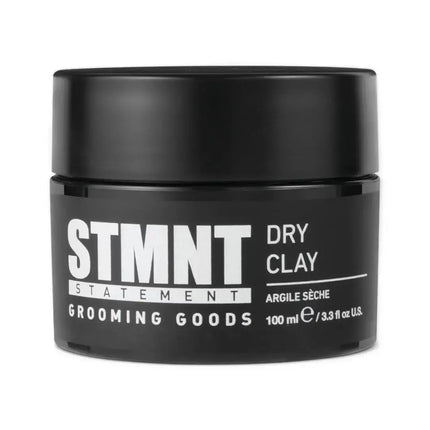 “STMNT Grooming Goods collection—Dry Clay, Fiber Pomade, and Shine Paste arranged on a barbershop counter.”