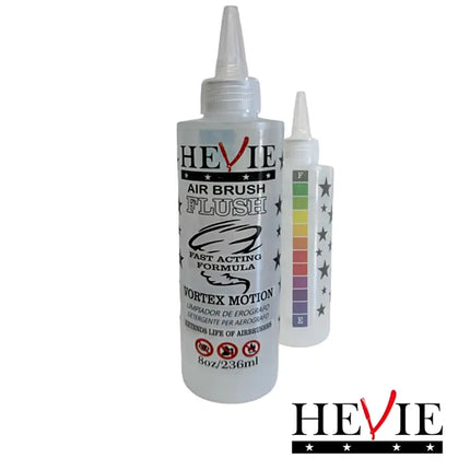 HEVIE Air Brush Flush bottle with a pointed applicator cap, shown with two smaller bottles behind it on a plain white background. The main bottle is white with black and red HEVIE branding and product text.