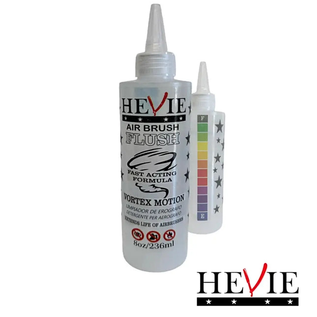 HEVIE Air Brush Flush bottle with a pointed applicator cap, shown with two smaller bottles behind it on a plain white background. The main bottle is white with black and red HEVIE branding and product text.