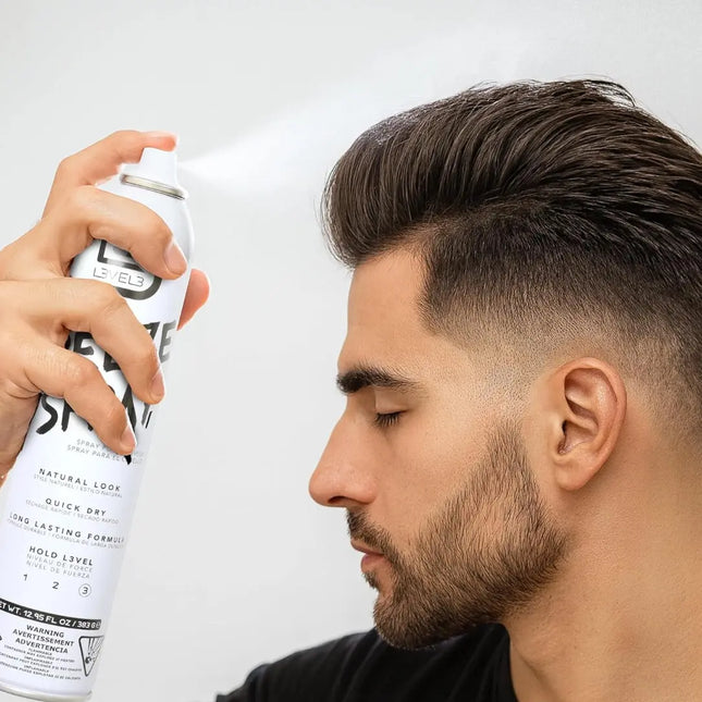 Man using a Level 3 hair spray can with a plain background