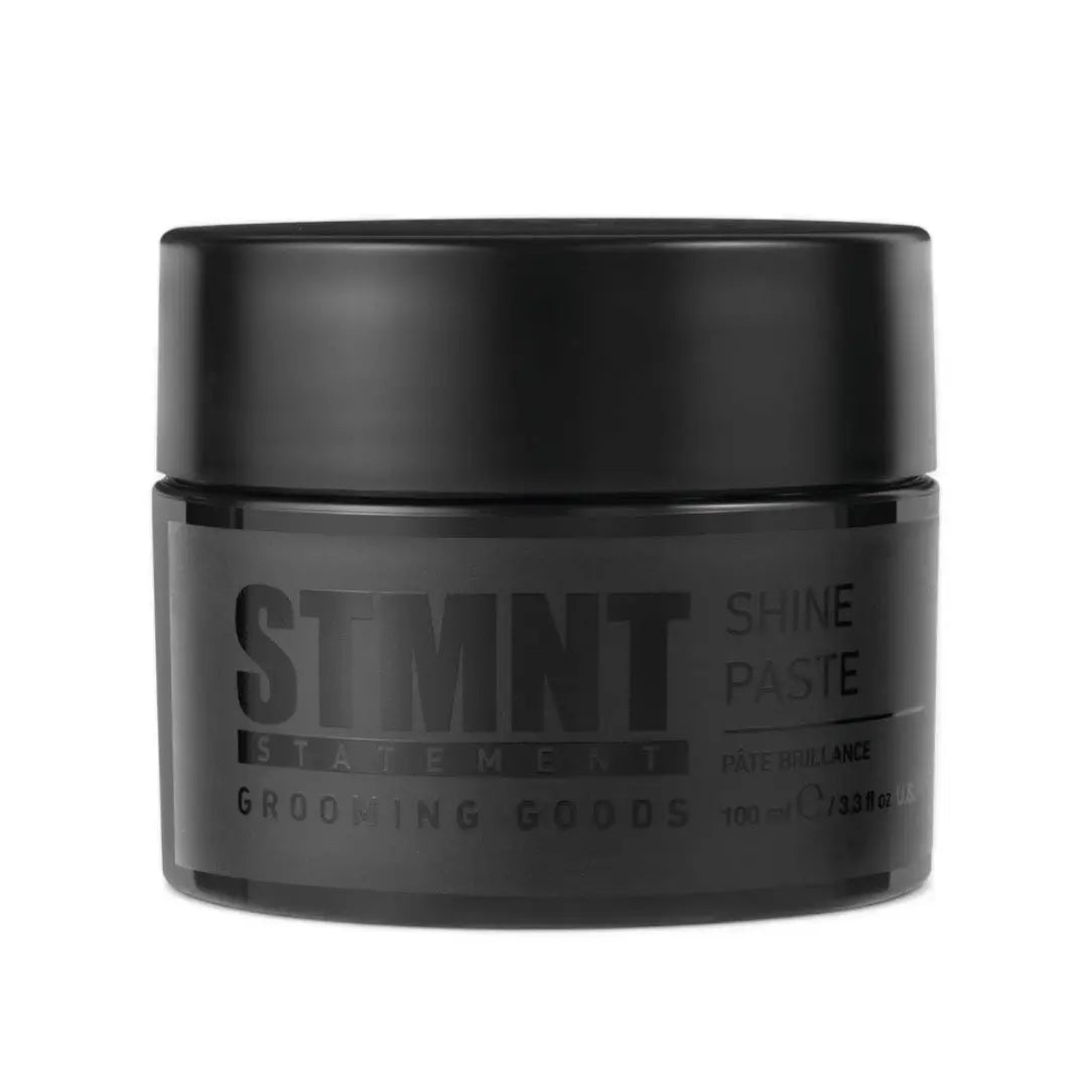 Black jar of STMNT Shine Paste on a white background