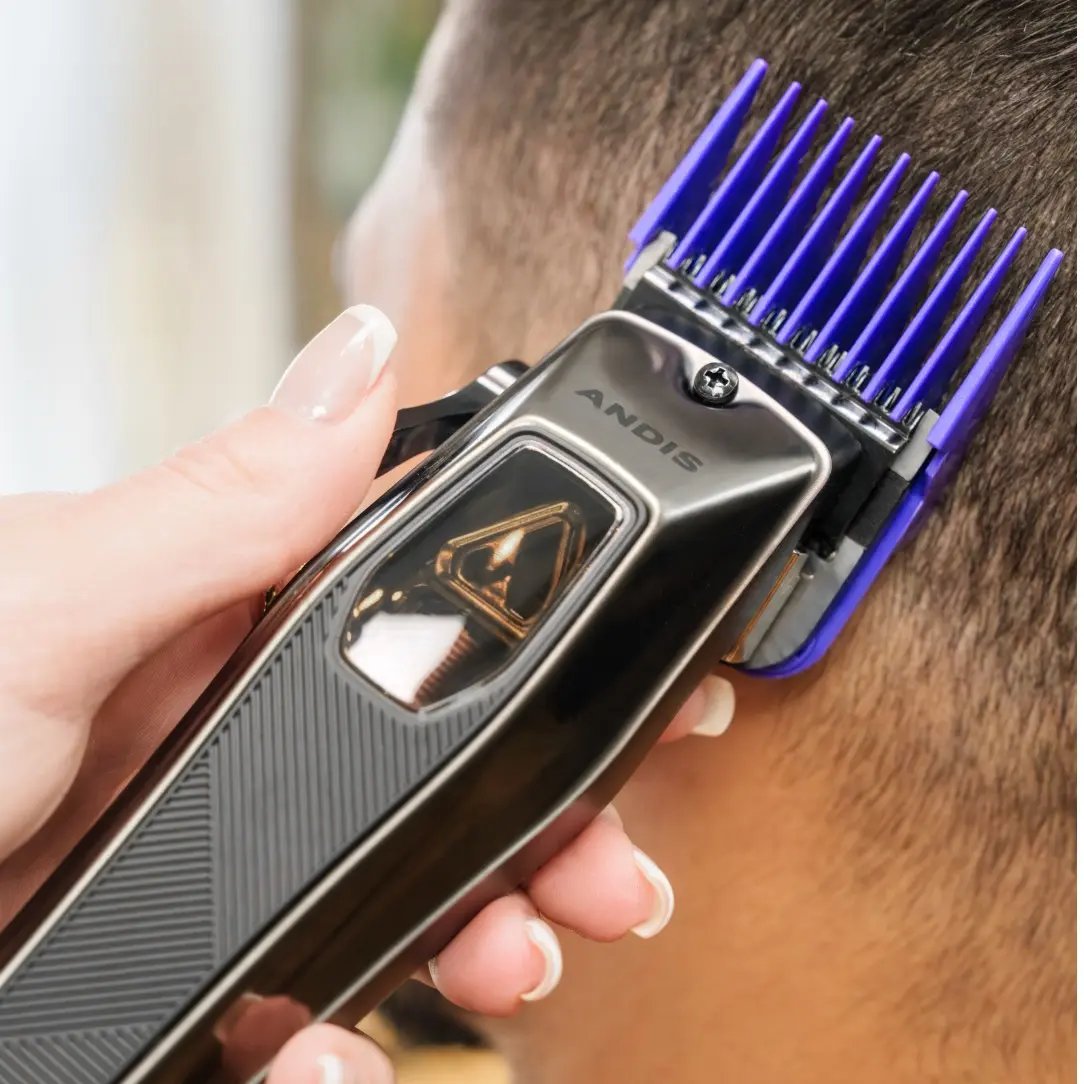 Andis hair trimmer being used on a person's head with a blurred background