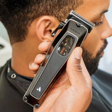 Person using an Andis hair trimmer on their head