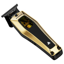 Gold and black Andis hair trimmer on a white background