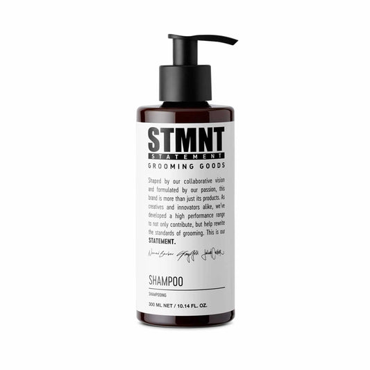 Shampoo bottle with pump labeled 'STMNT Grooming Goods' on a white background