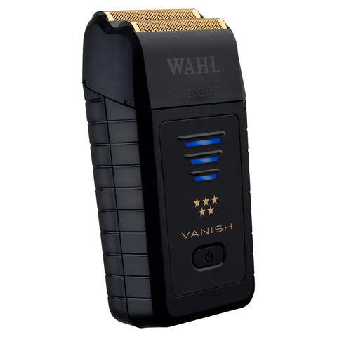 “Barber finishing a skin fade with Wahl Vanish foil shaver on client’s neckline.”

