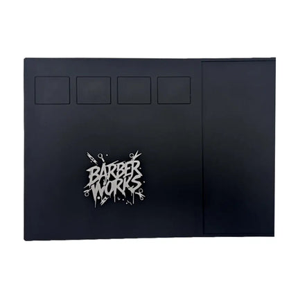 A black rectangular product, likely a case or cover, featuring a stylized silver 'BARBER WORKS' logo on the lower left and four recessed square panels near the top, shown against a plain white background.